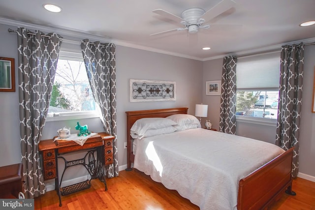 bedroom with ceiling fan, hardwood / wood-style floors, and crown molding