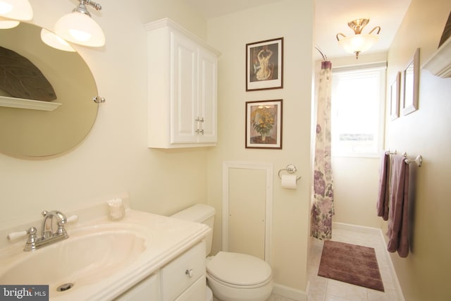 bathroom featuring tile patterned flooring, vanity, and toilet