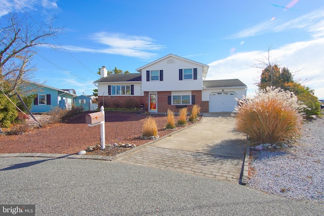 35 Walkill Rd, Little Egg Harbor Twp, NJ 08087 - tri-level home featuring an attached garage, driveway, brick siding, and a chimney