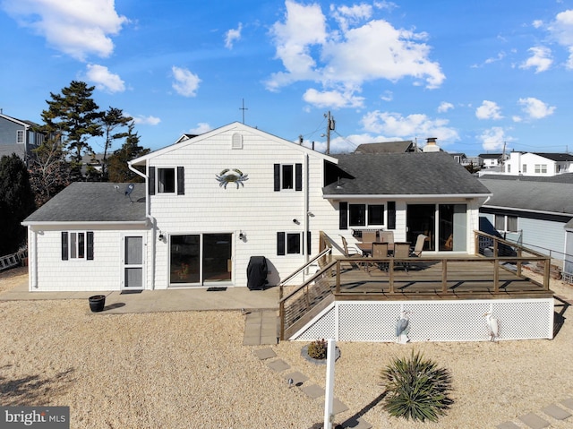 back of house featuring a wooden deck