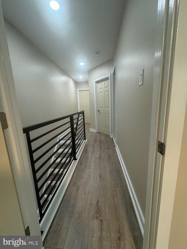 corridor with dark hardwood / wood-style floors