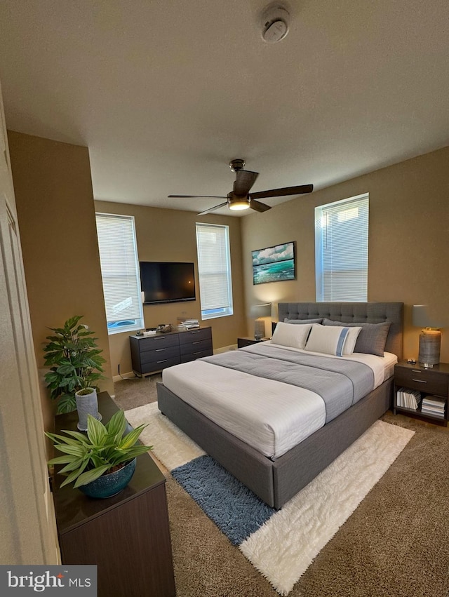 bedroom featuring light colored carpet and ceiling fan