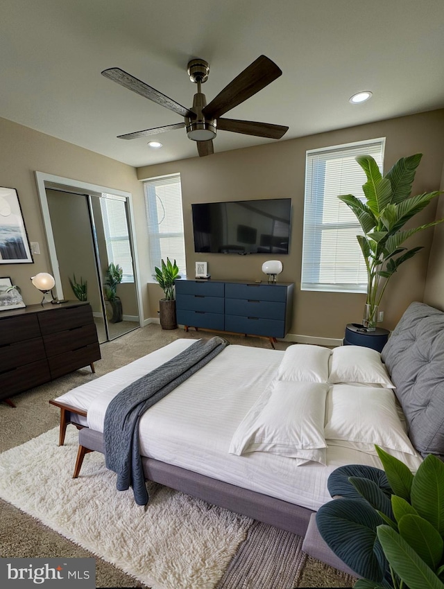 bedroom featuring carpet flooring, ceiling fan, and a closet