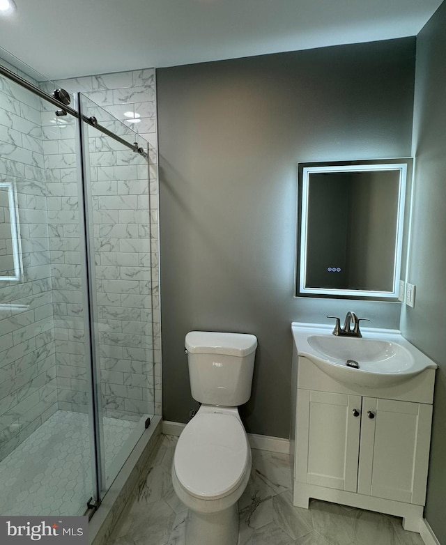 bathroom with vanity, toilet, and a shower with shower door