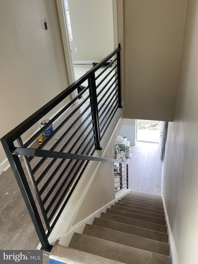 stairway featuring hardwood / wood-style flooring