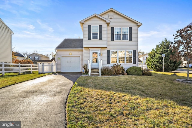 view of property with a front lawn and a garage