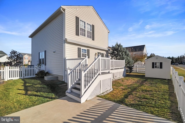 exterior space featuring a wooden deck, a yard, and a shed