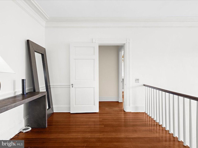 corridor with hardwood / wood-style floors and ornamental molding