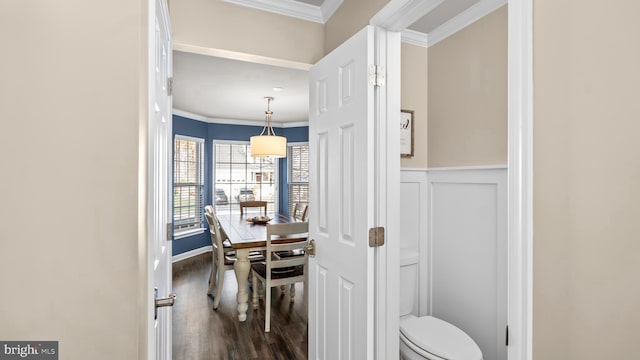 dining space featuring crown molding and hardwood / wood-style flooring