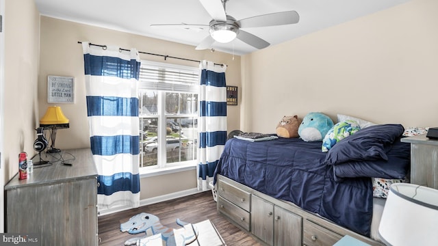 bedroom with ceiling fan and dark hardwood / wood-style flooring