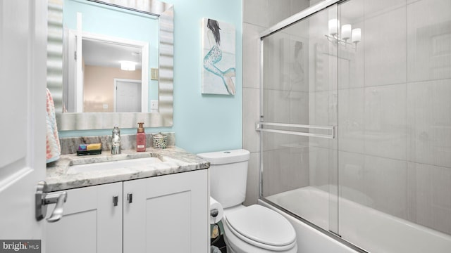 full bathroom with toilet, vanity, and combined bath / shower with glass door