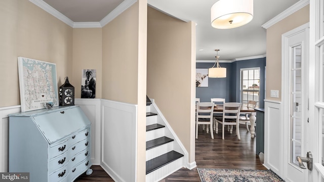 stairs featuring hardwood / wood-style floors and ornamental molding