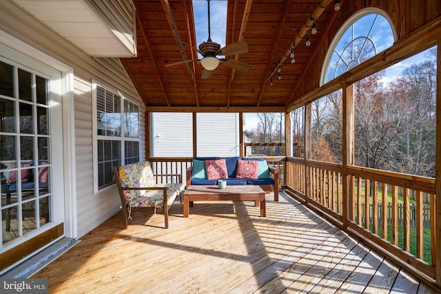 sunroom with lofted ceiling with beams, ceiling fan, and wood ceiling