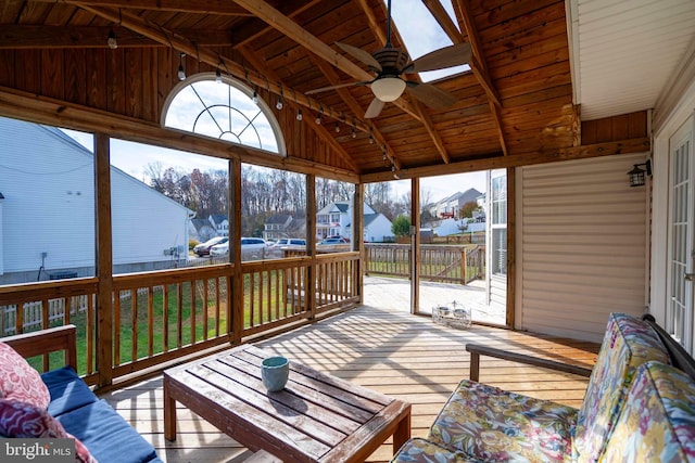 sunroom / solarium with ceiling fan, lofted ceiling with beams, and wooden ceiling