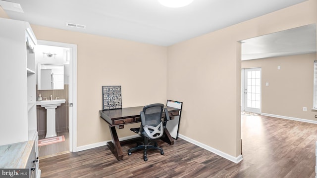 office area with dark hardwood / wood-style flooring and sink