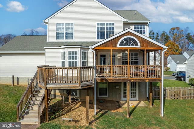 back of house with a wooden deck and a yard