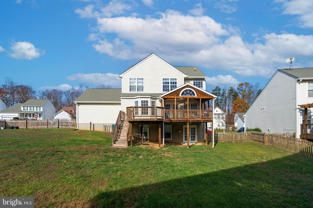 back of property featuring a lawn and a wooden deck