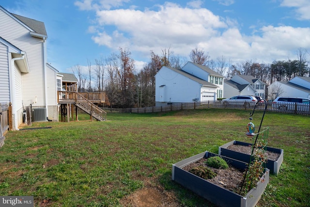 view of yard featuring central AC unit and a wooden deck