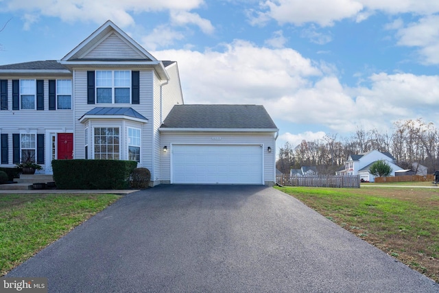 view of front of property with a garage and a front yard