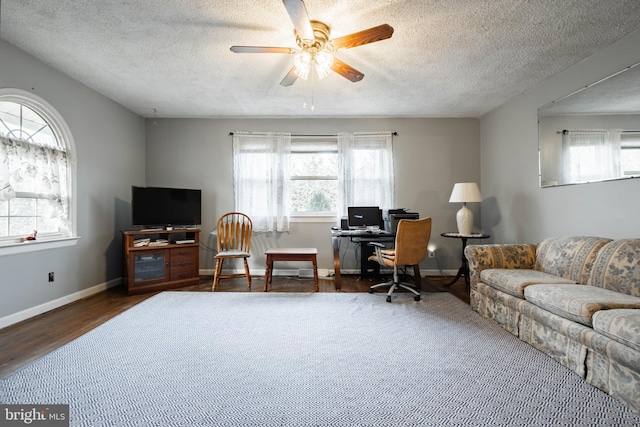 office featuring a textured ceiling, dark hardwood / wood-style flooring, and a healthy amount of sunlight