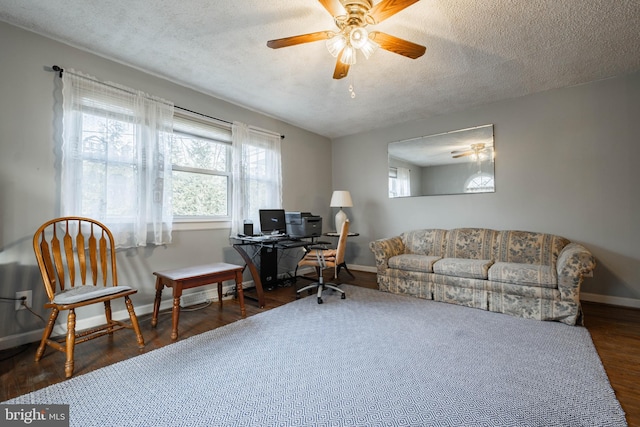 office space with ceiling fan, dark hardwood / wood-style flooring, and a textured ceiling