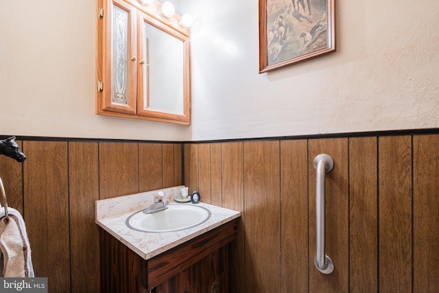 bathroom with wooden walls and vanity