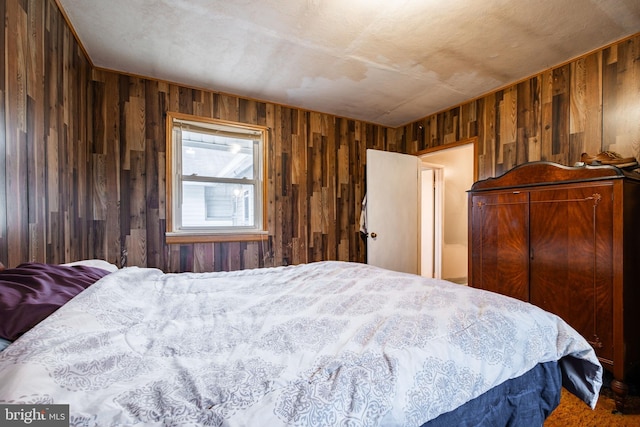 bedroom with wood walls