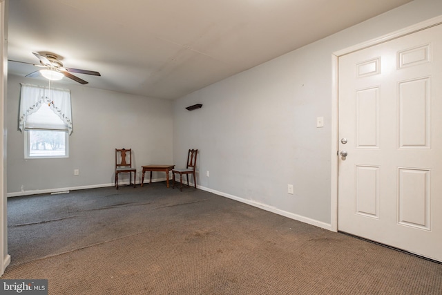 spare room featuring carpet floors and ceiling fan