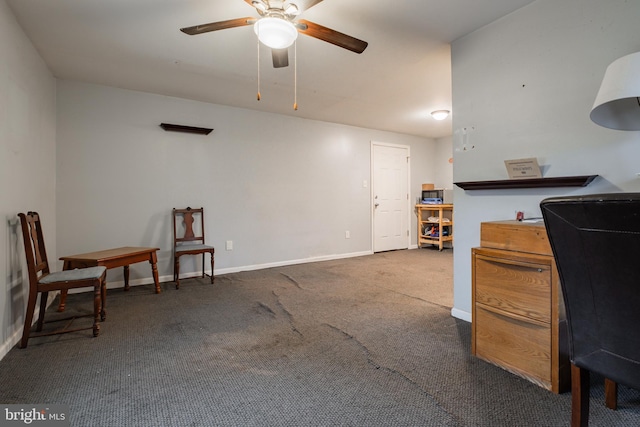 carpeted home office featuring ceiling fan