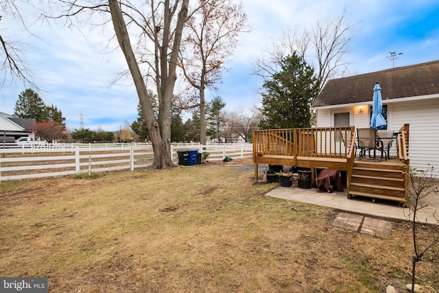 view of yard with a rural view and a wooden deck