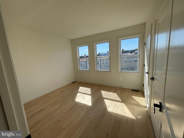 unfurnished room with light hardwood / wood-style flooring