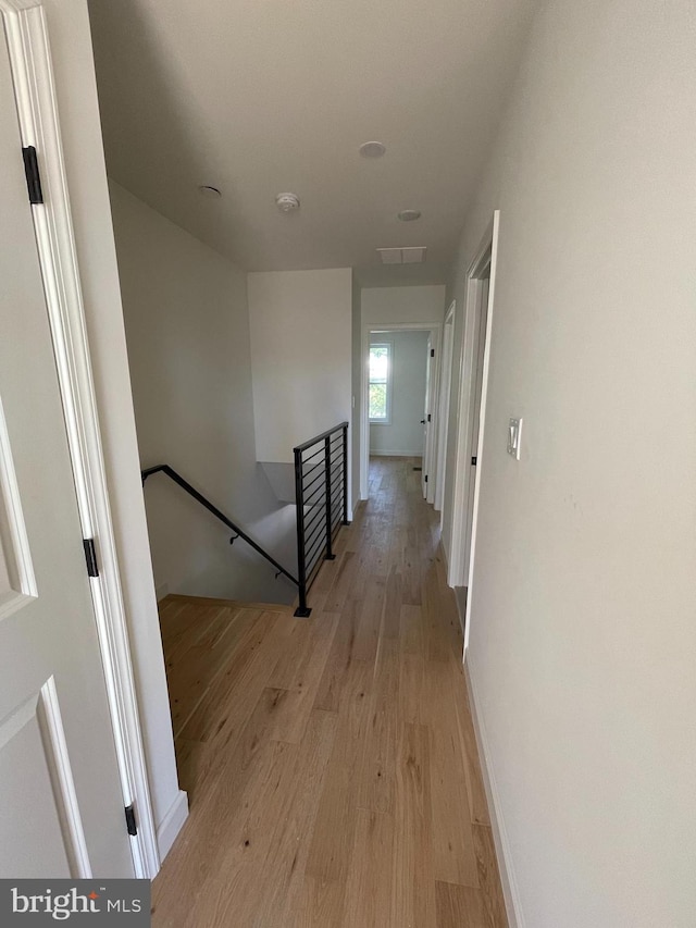 hallway with light hardwood / wood-style flooring