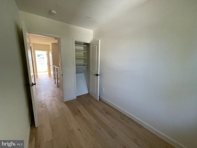 corridor with light wood-type flooring