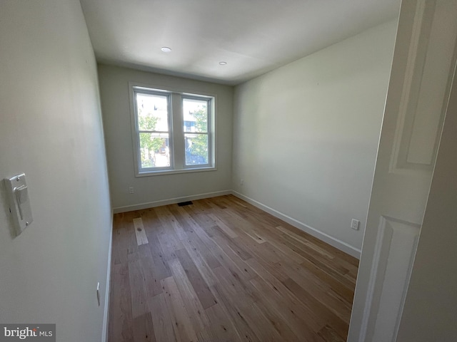 empty room with light hardwood / wood-style floors