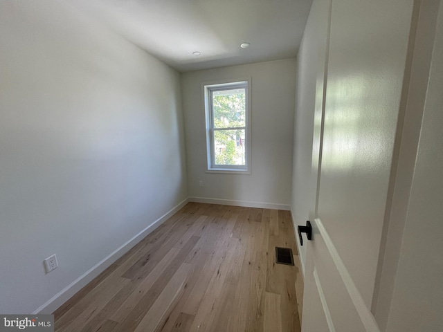 unfurnished room with light wood-type flooring