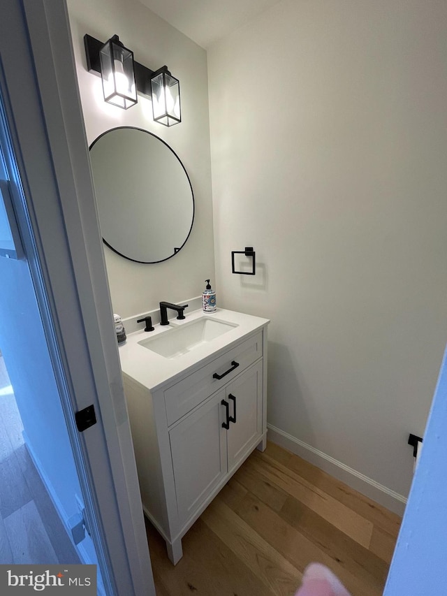 bathroom with hardwood / wood-style floors and vanity