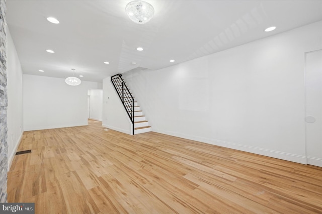 basement with light hardwood / wood-style flooring