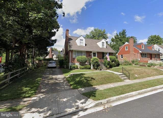 new england style home featuring a front yard