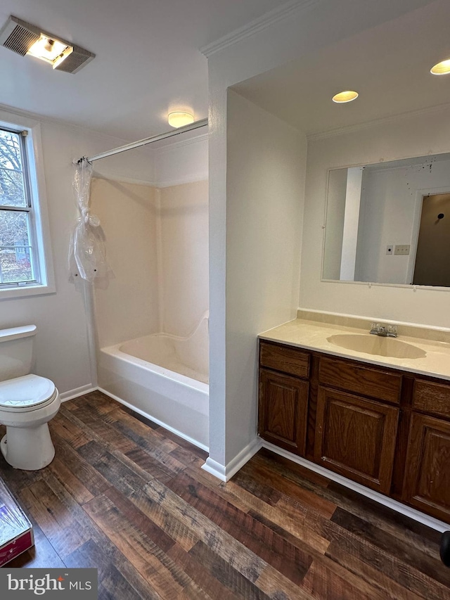 full bathroom with bathing tub / shower combination, hardwood / wood-style floors, vanity, and toilet