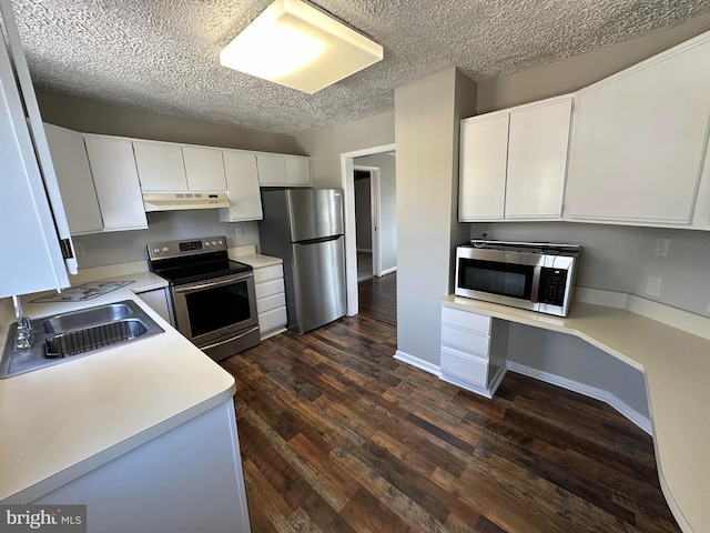 8579 Nursery Rd, Lusby, MD 20657 - kitchen featuring appliances with stainless steel finishes, a sink, under cabinet range hood, light countertops, and dark wood-style flooring