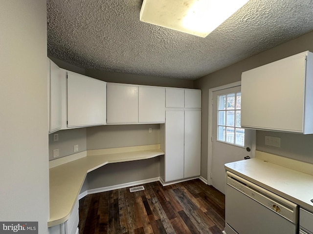 kitchen featuring dishwasher, dark hardwood / wood-style floors, white cabinetry, and a textured ceiling