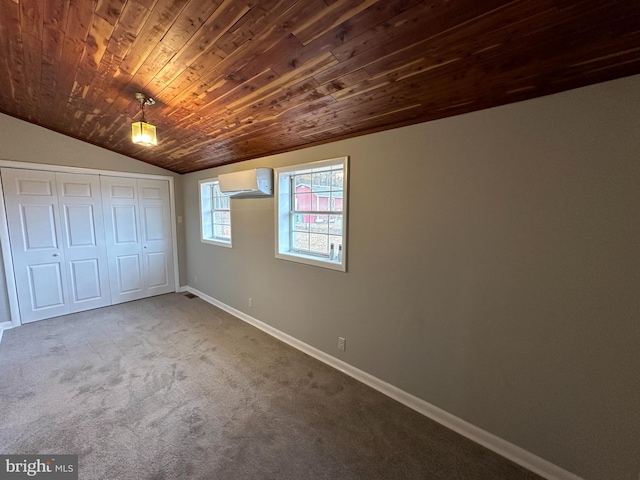 unfurnished bedroom featuring vaulted ceiling, an AC wall unit, wooden ceiling, carpet floors, and a closet