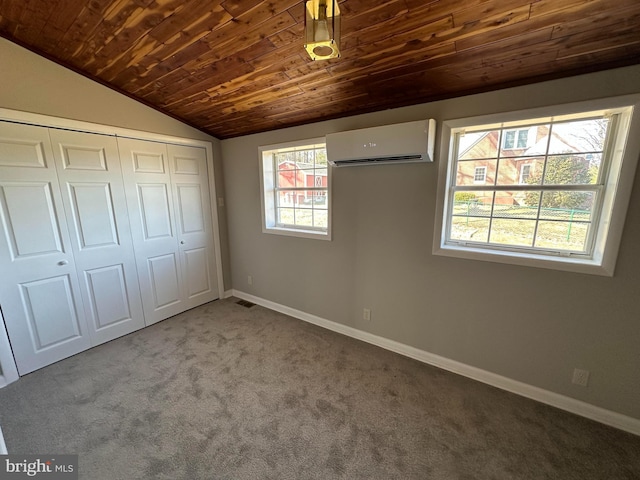 8579 Nursery Rd, Lusby, MD 20657 - unfurnished bedroom featuring a wall mounted AC, vaulted ceiling, carpet, wood ceiling, and baseboards