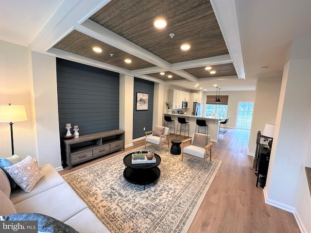 living room featuring beamed ceiling, light hardwood / wood-style floors, coffered ceiling, and wooden ceiling