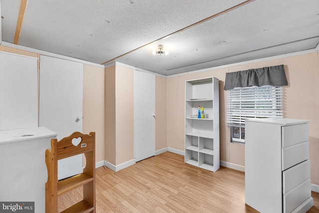 basement with hardwood / wood-style flooring and a textured ceiling