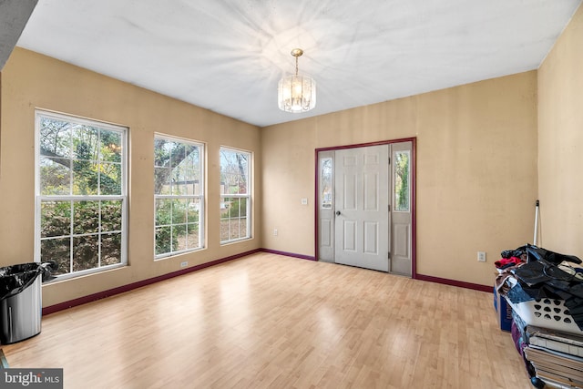 entryway featuring a chandelier and light hardwood / wood-style floors