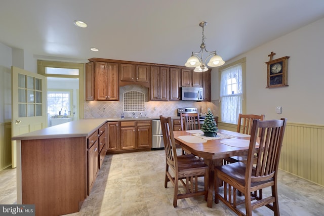 dining area featuring an inviting chandelier and sink