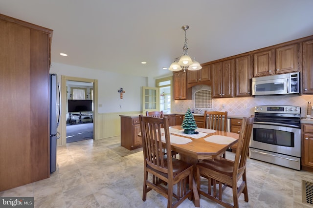 dining space featuring an inviting chandelier