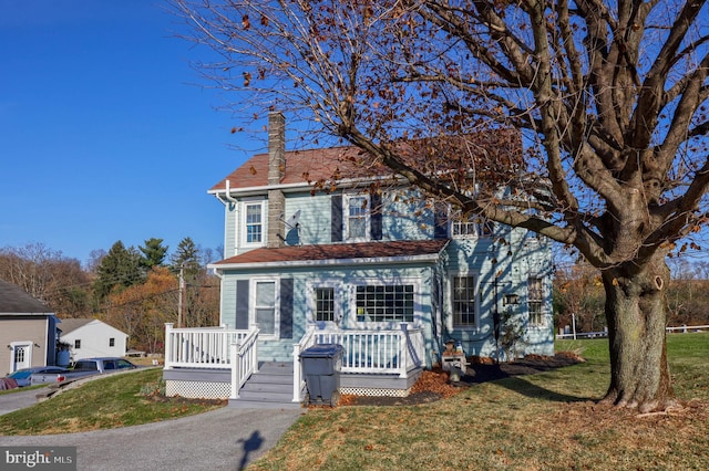 view of front of house featuring a front yard and a deck