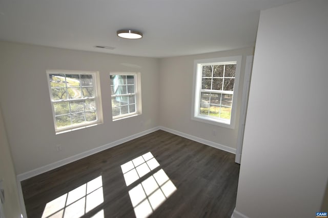 empty room with dark hardwood / wood-style flooring